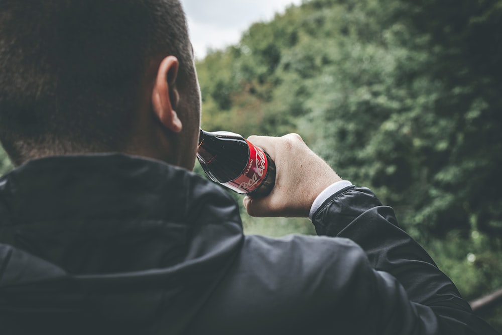 man drinking cola