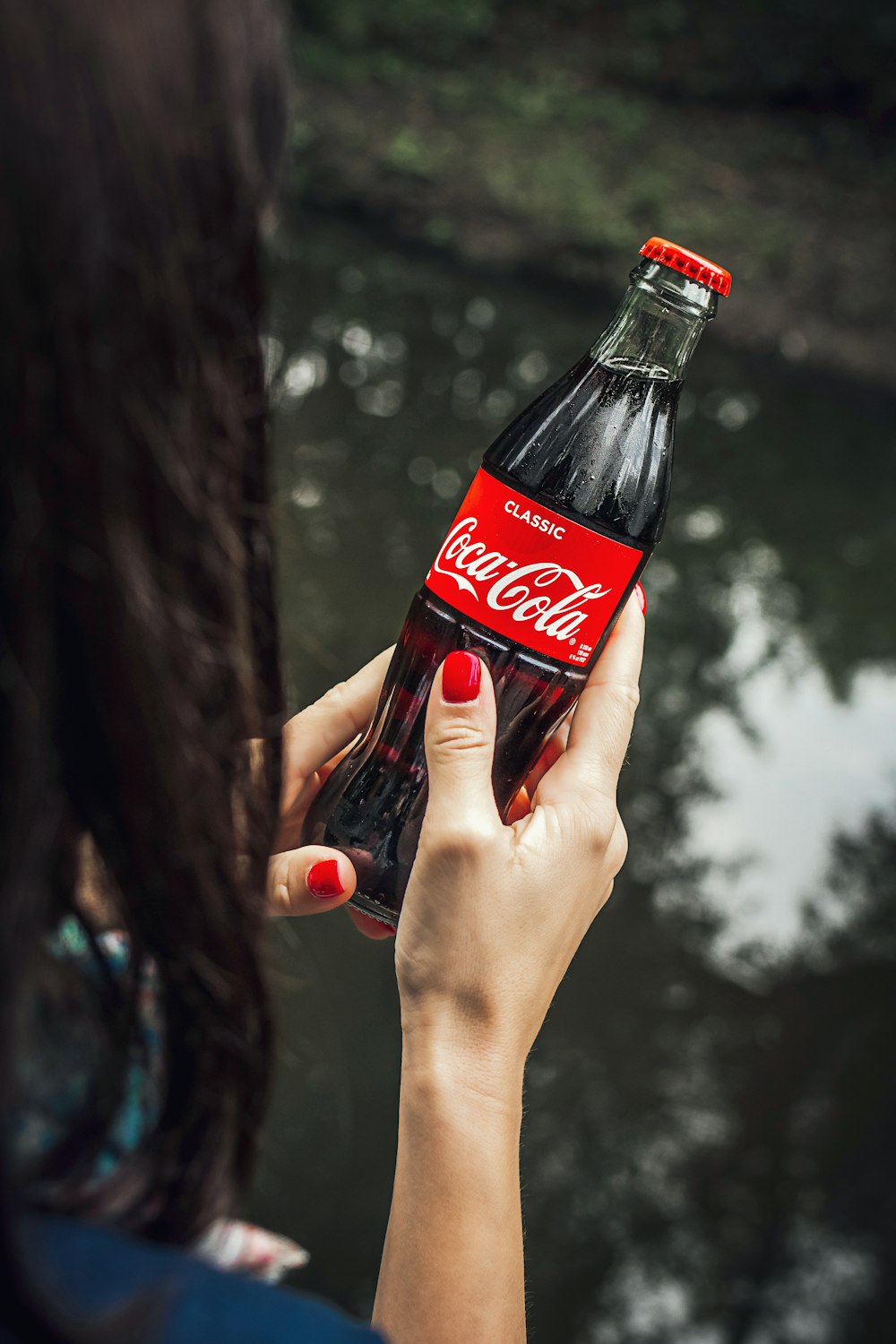 Women Holding A Red Coca Cola Bottle During Daytime Photo Free Beverage Image On Unsplash