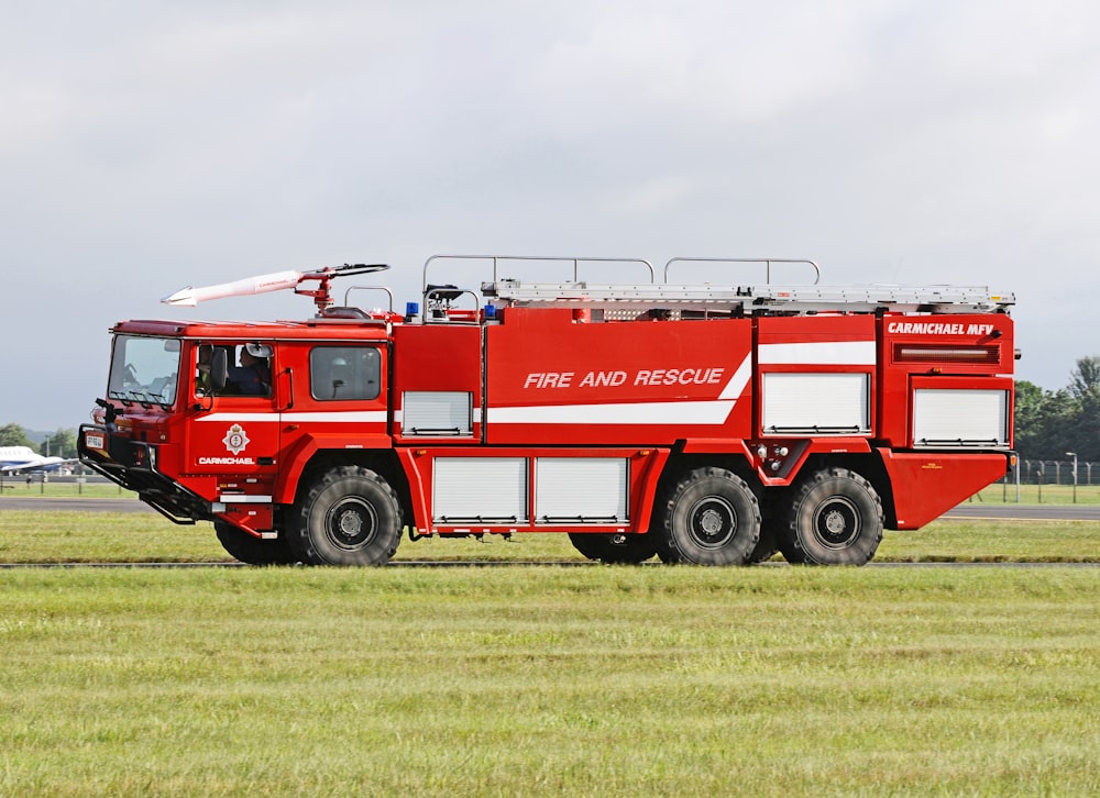 red and white fire engine on green grass field