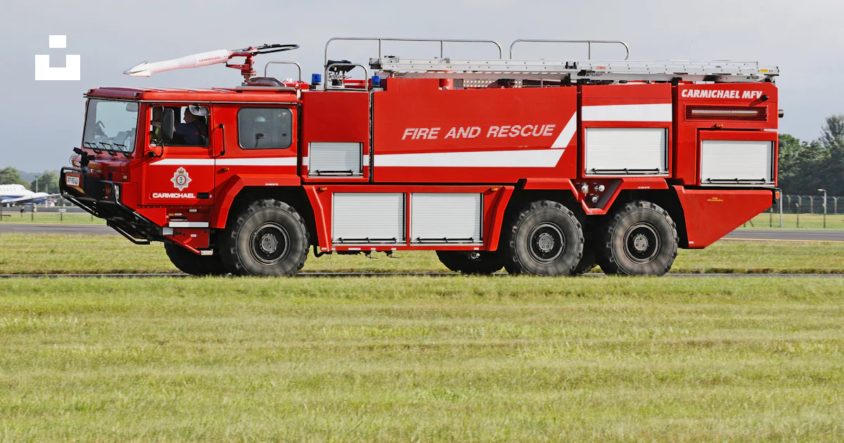 Red and white fire engine on green grass field photo – Free Raf ...