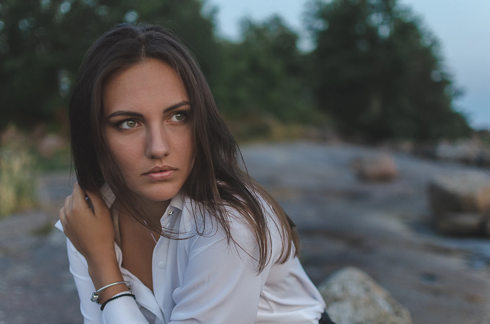 A crisp white button-up collared shirt with a structured point collar, worn open at the neck