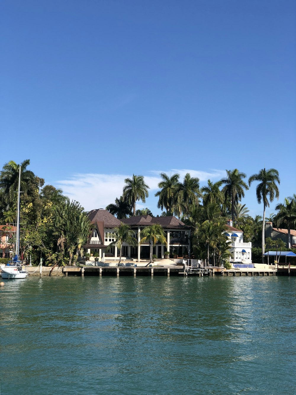 white and brown buildings beside body of water during daytime