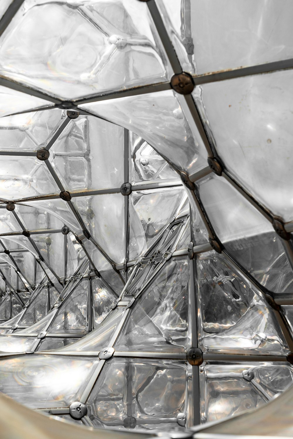 a close up of a glass structure with metal bars