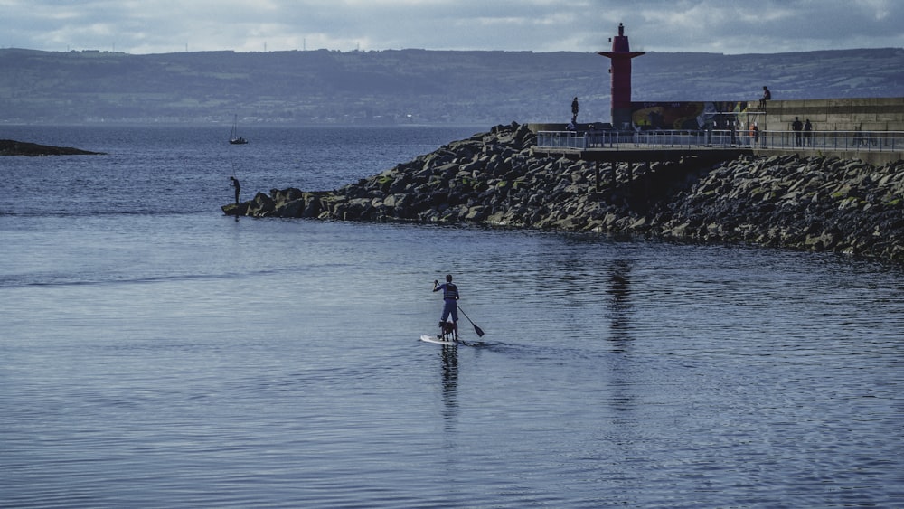 person riding surfboard during daytime