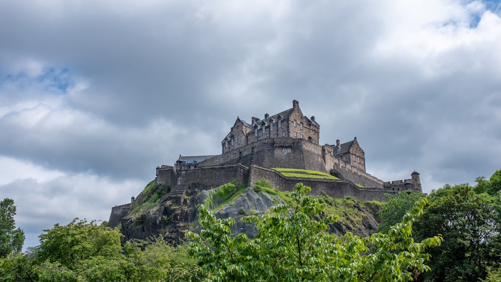 photography of gray building on top of mountain during daytime