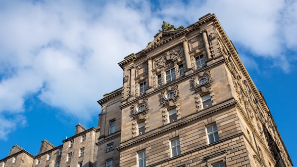 Ornate Victorian heritage building with carved stone details against blue sky