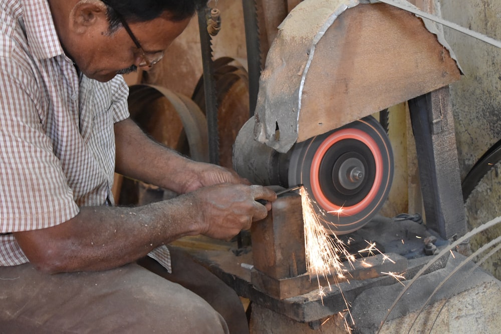 man sitting beside machine