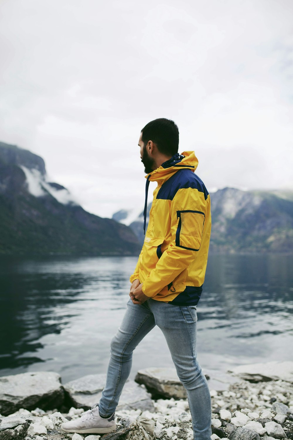 unknown person standing near body of water