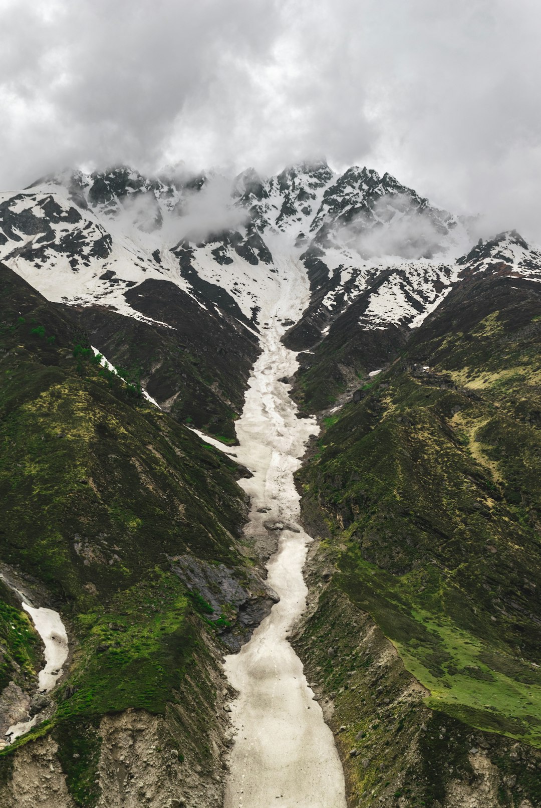 white and green mountain under white sky at daytime