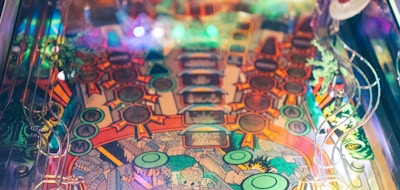 blue and multicolored pinball machine close-up photography
