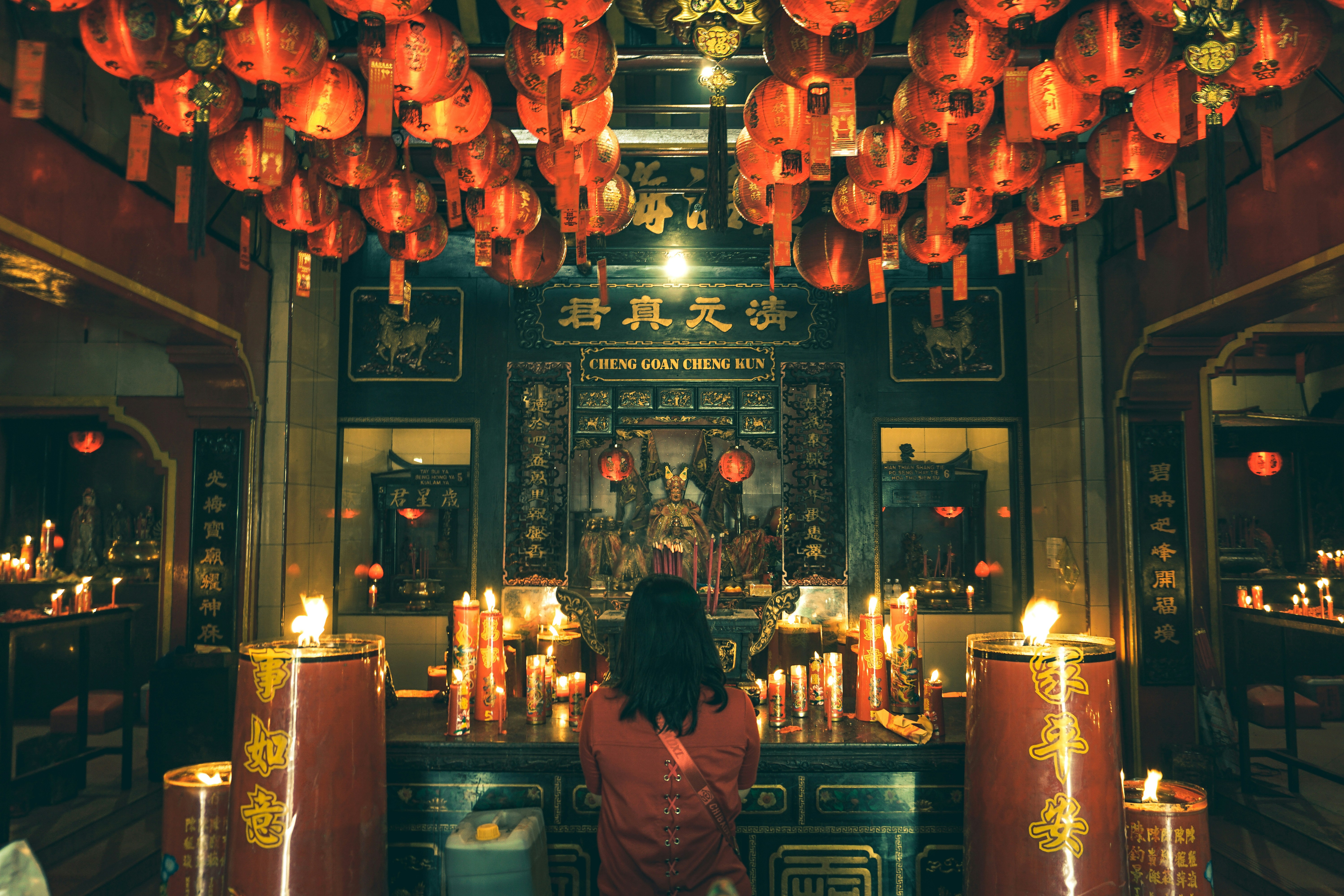 red women pray in temple with red ornament 