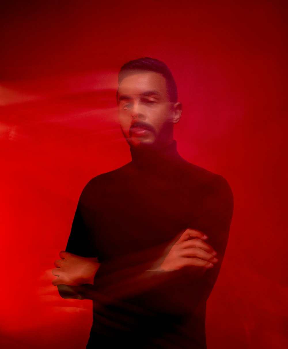 man wearing black turtleneck shirt standing