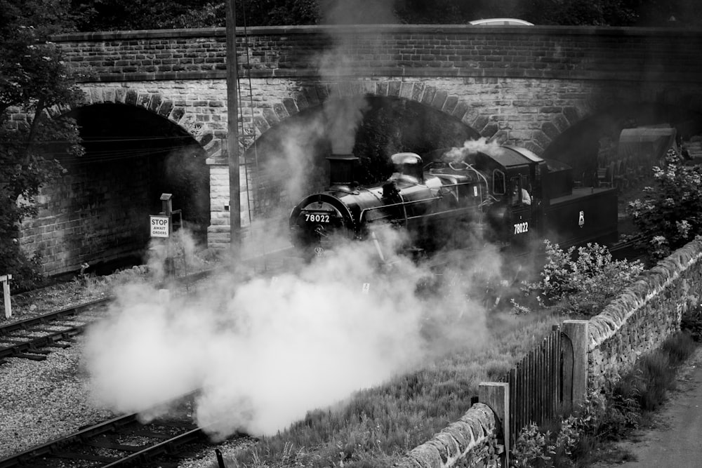 train on railway grayscale photography