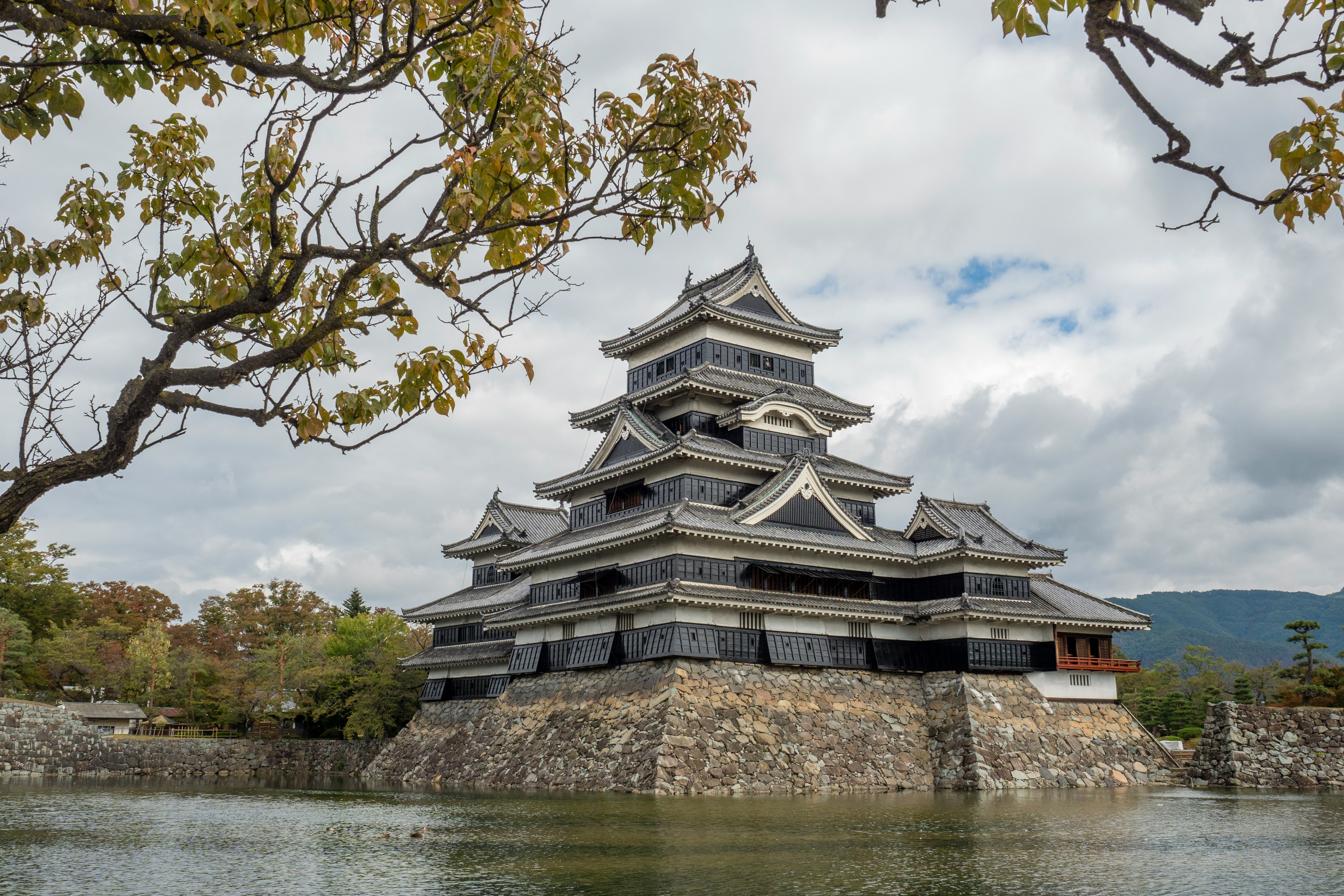 gray and black concrete building near body of water