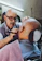 Elegant close-up of a man enjoying a traditional straight razor shave in a luxurious barber shop.