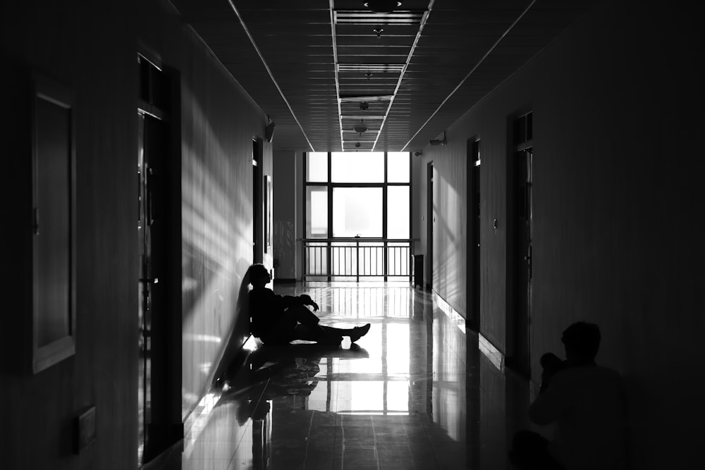 person sitting on hallway