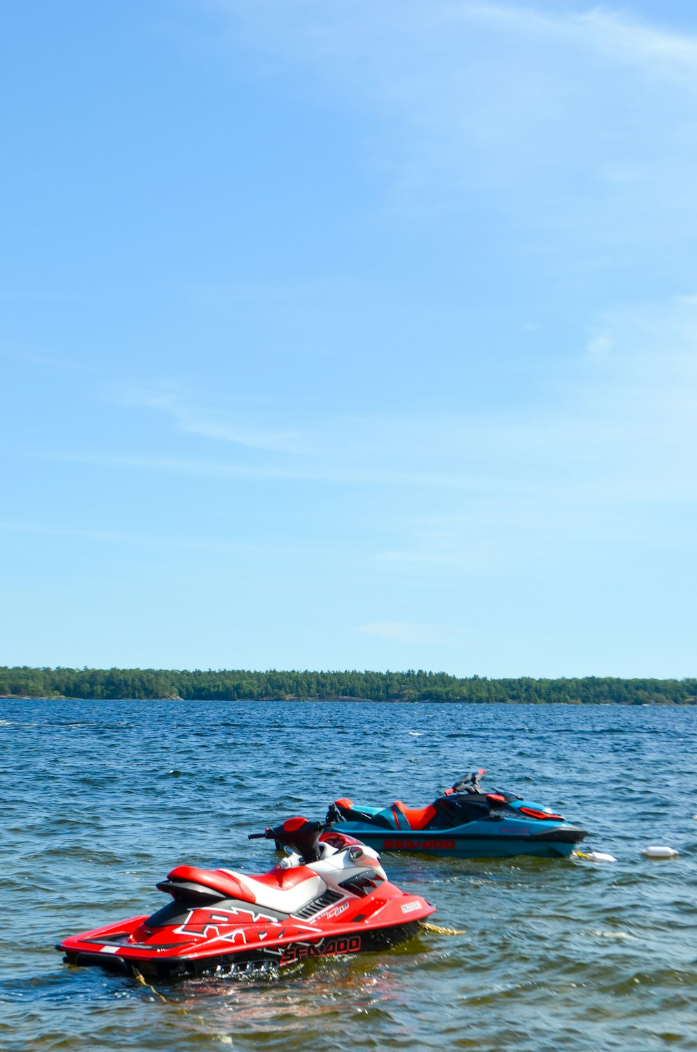 blue and red personal watercrafts