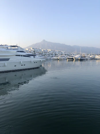 A serene early morning view of a luxury boat gently anchored in the calm waters of La Spezia’s harbor.