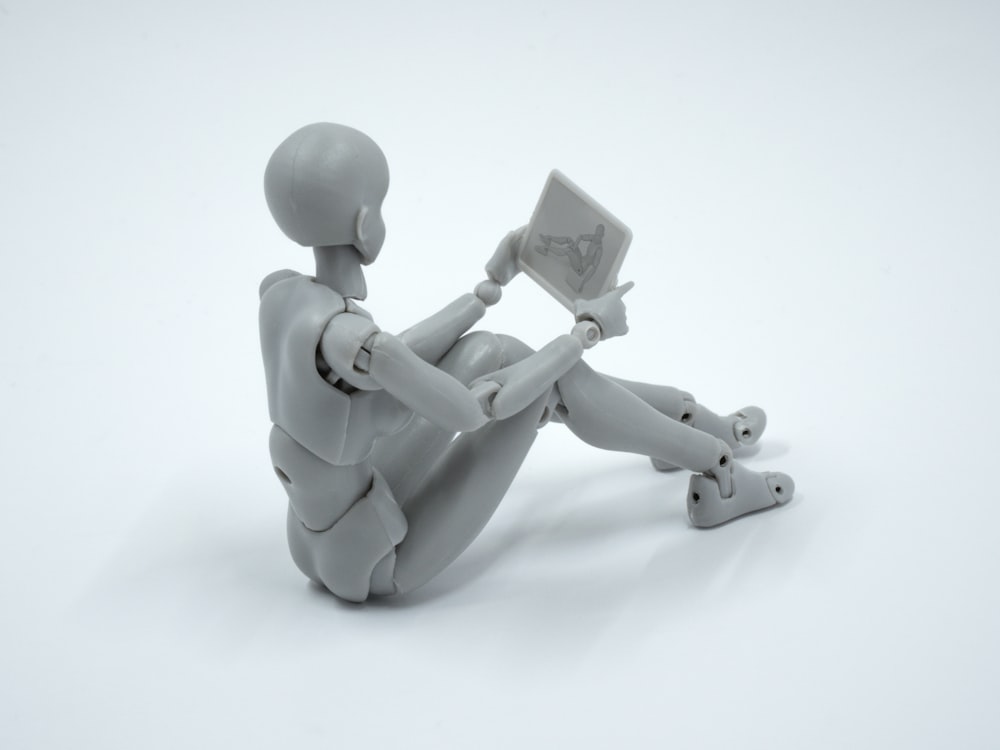 a person sitting on the ground with a laptop