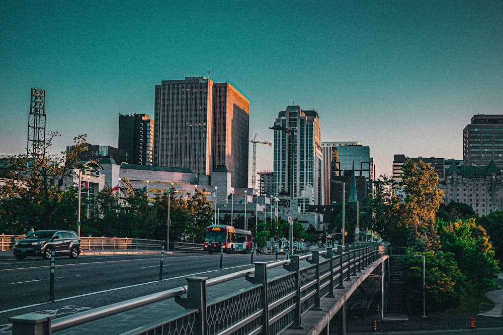 vehicles on bridge near high-rise buildings