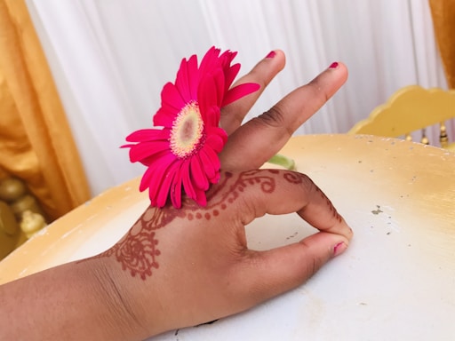 Elegant arrangement of beige and soft pink wedding decorations with delicate henna accessories displayed.