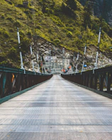 a long bridge with a mountain in the background