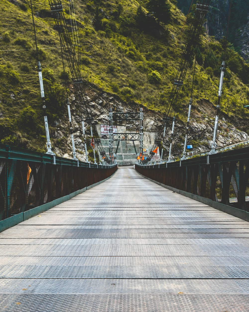 a long bridge with a mountain in the background