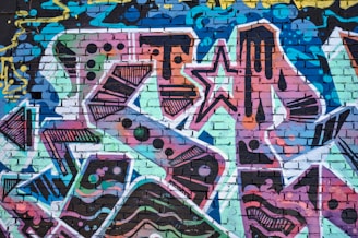 Detail of graffiti-style communication symbols blending with tropical flora on the mural.
