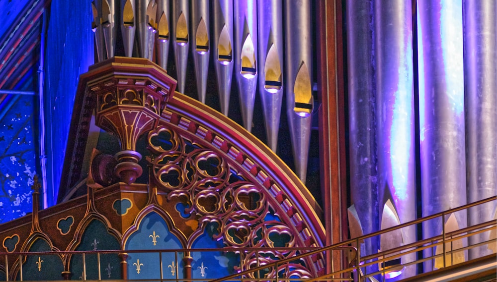 a pipe organ in a church with blue lighting