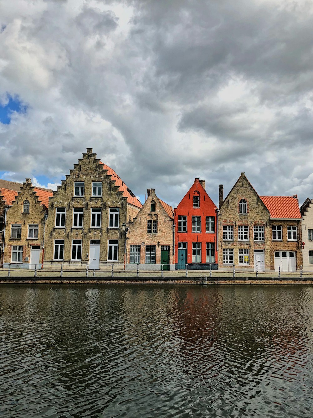brown concrete houses near calm water
