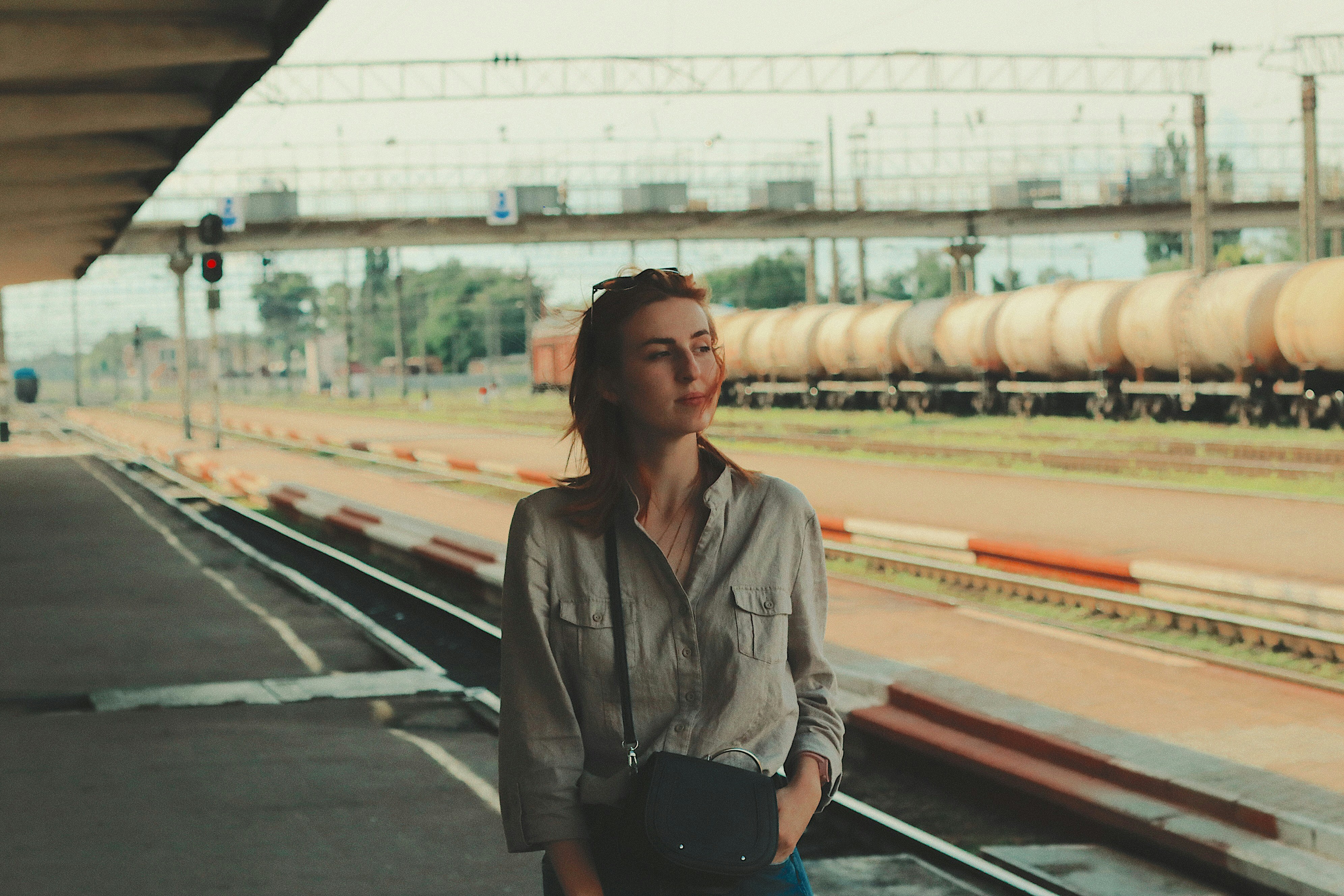 a woman standing in front of a train station