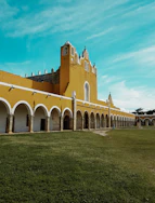 brown and white building under teal sky