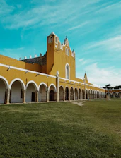 brown and white building under teal sky