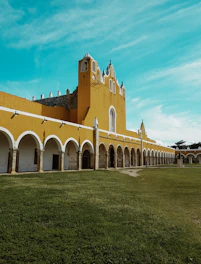 brown and white building under teal sky