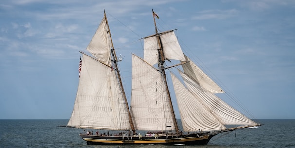 white and brown sailboat