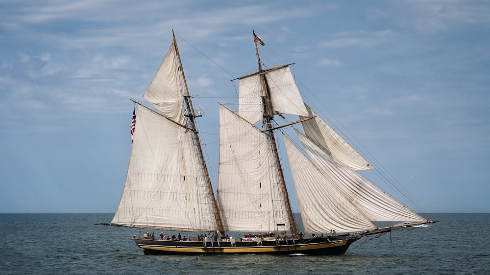 white and brown sailboat