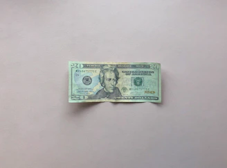 Macro shot of the fine print and watermark on a US twenty-dollar bill under bright light.