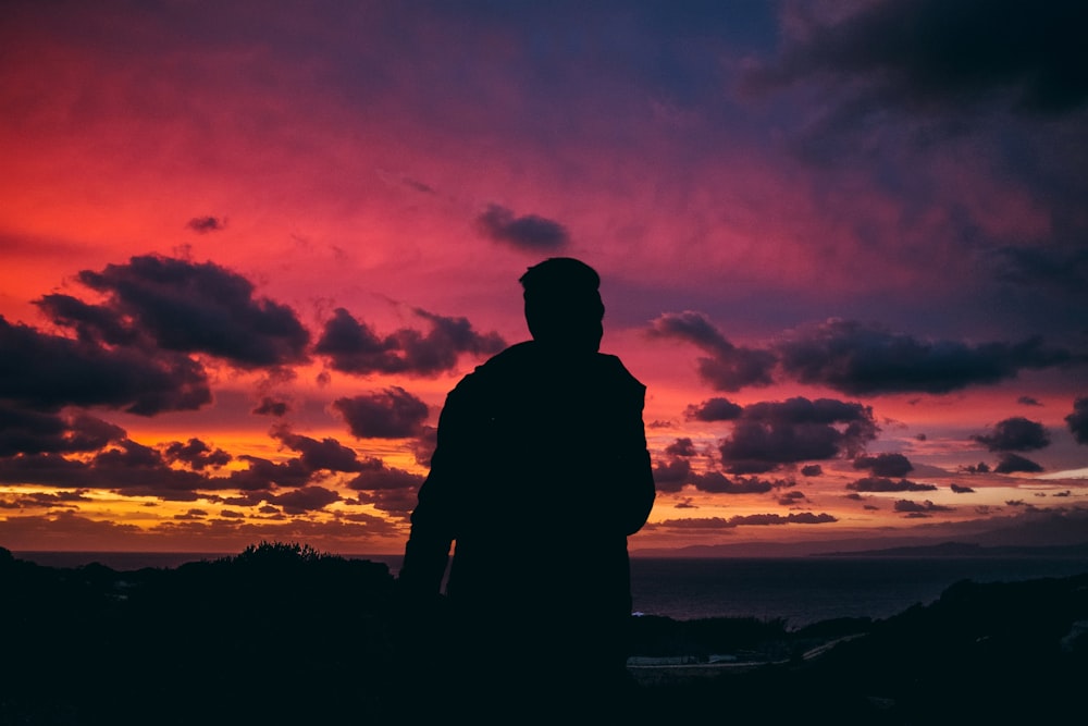 silhouette of man during golden hour