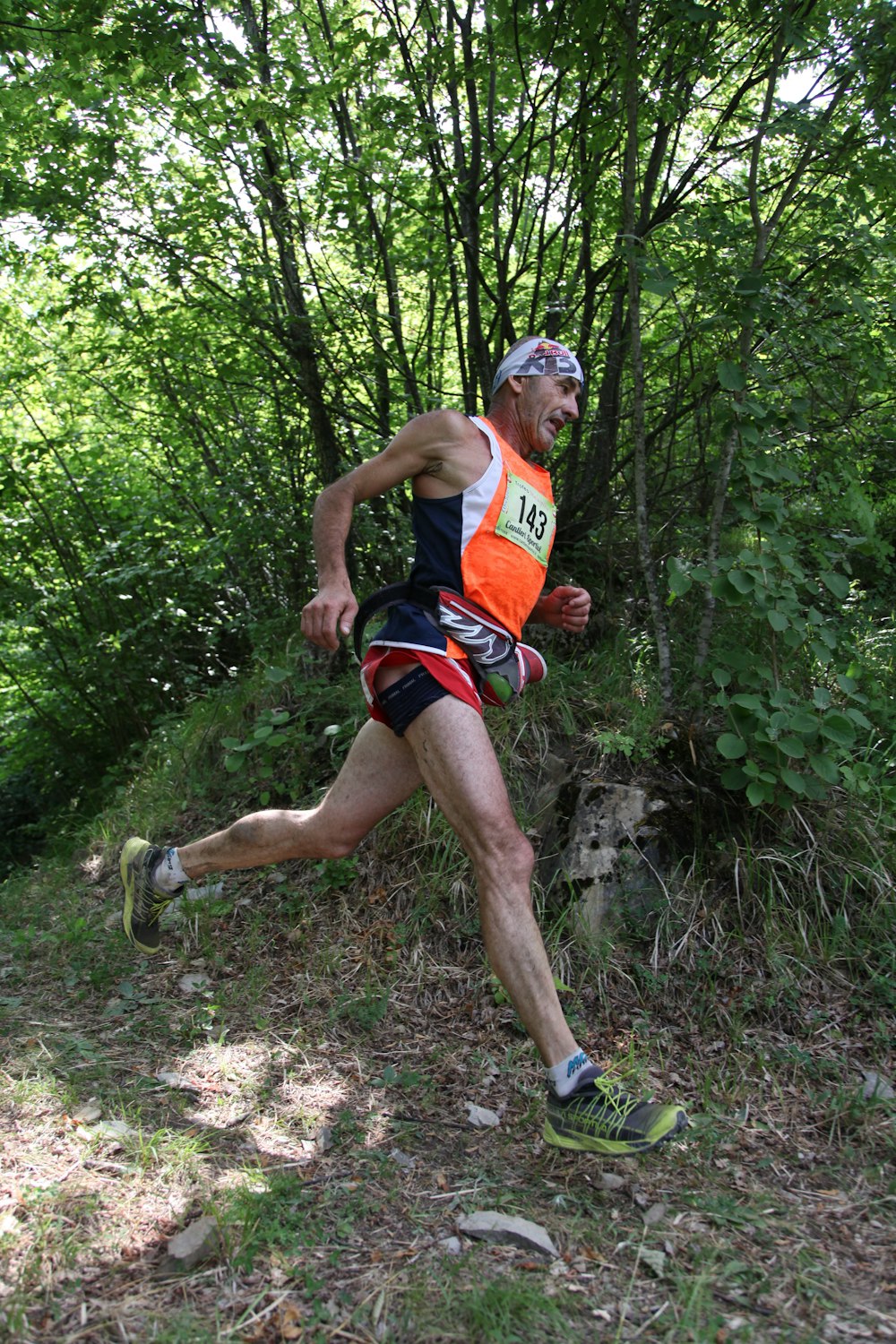 close-up photography of man running near t rees