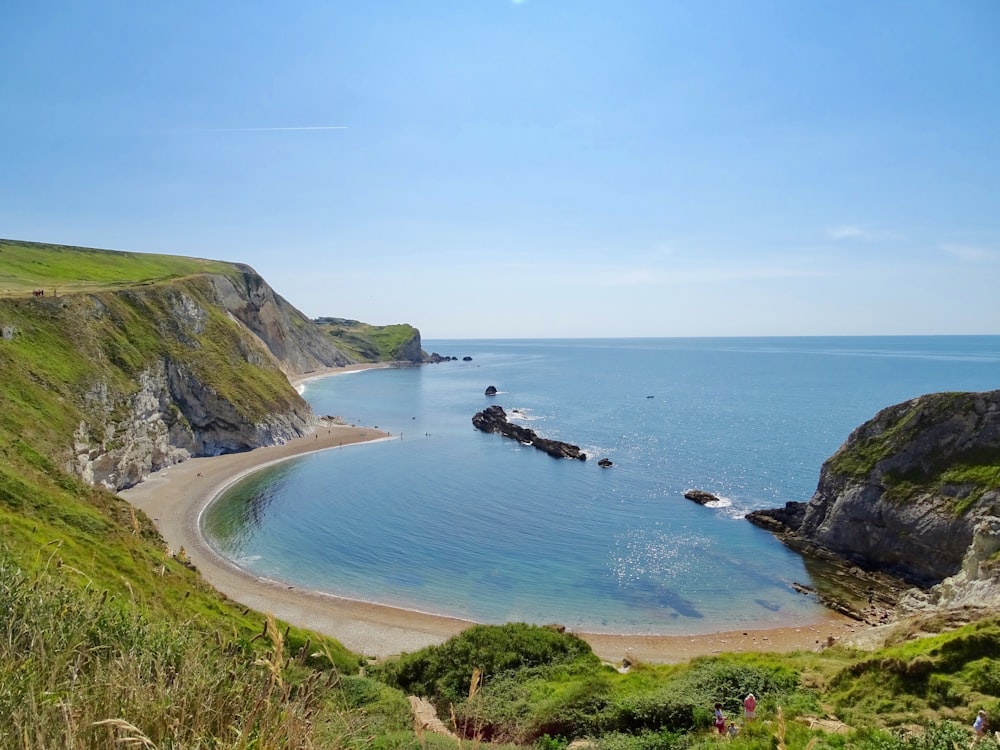 a view of a beach from a hill overlooking the ocean