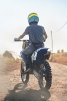 A happy customer riding their customized mini motorx on a winding trail.