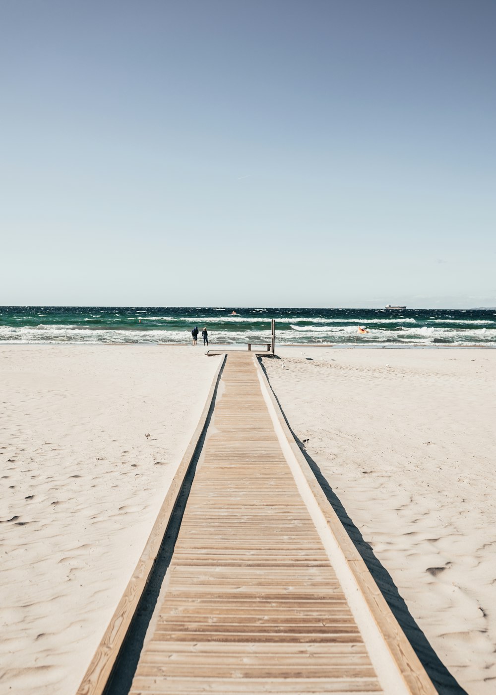 a long wooden walkway leading to the beach