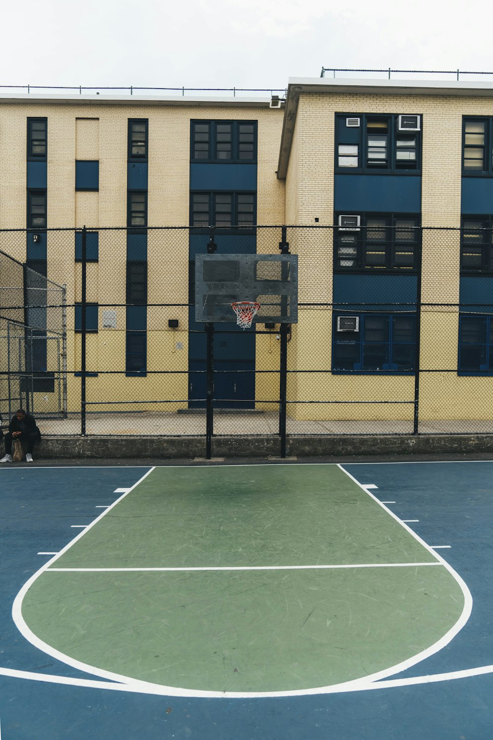 a basketball court in front of a building