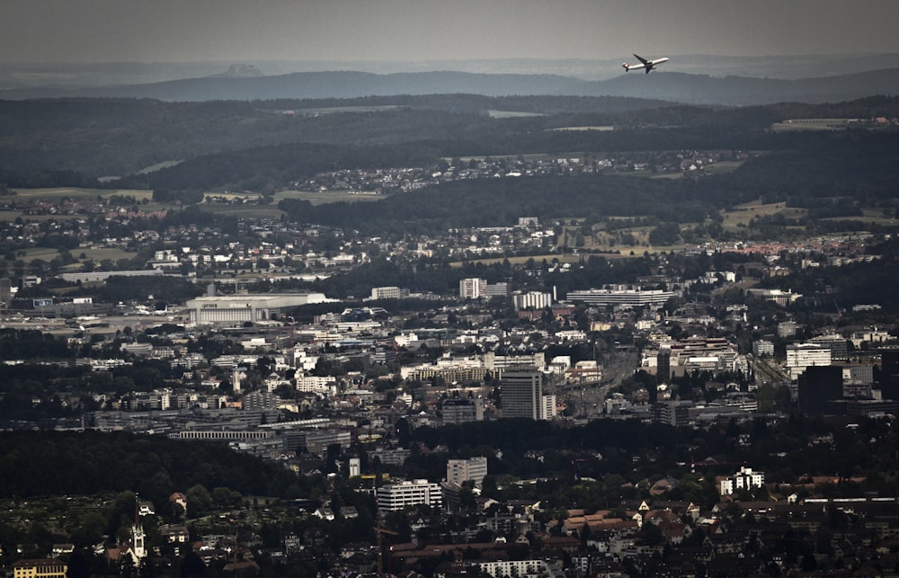 airplane flying over buildings