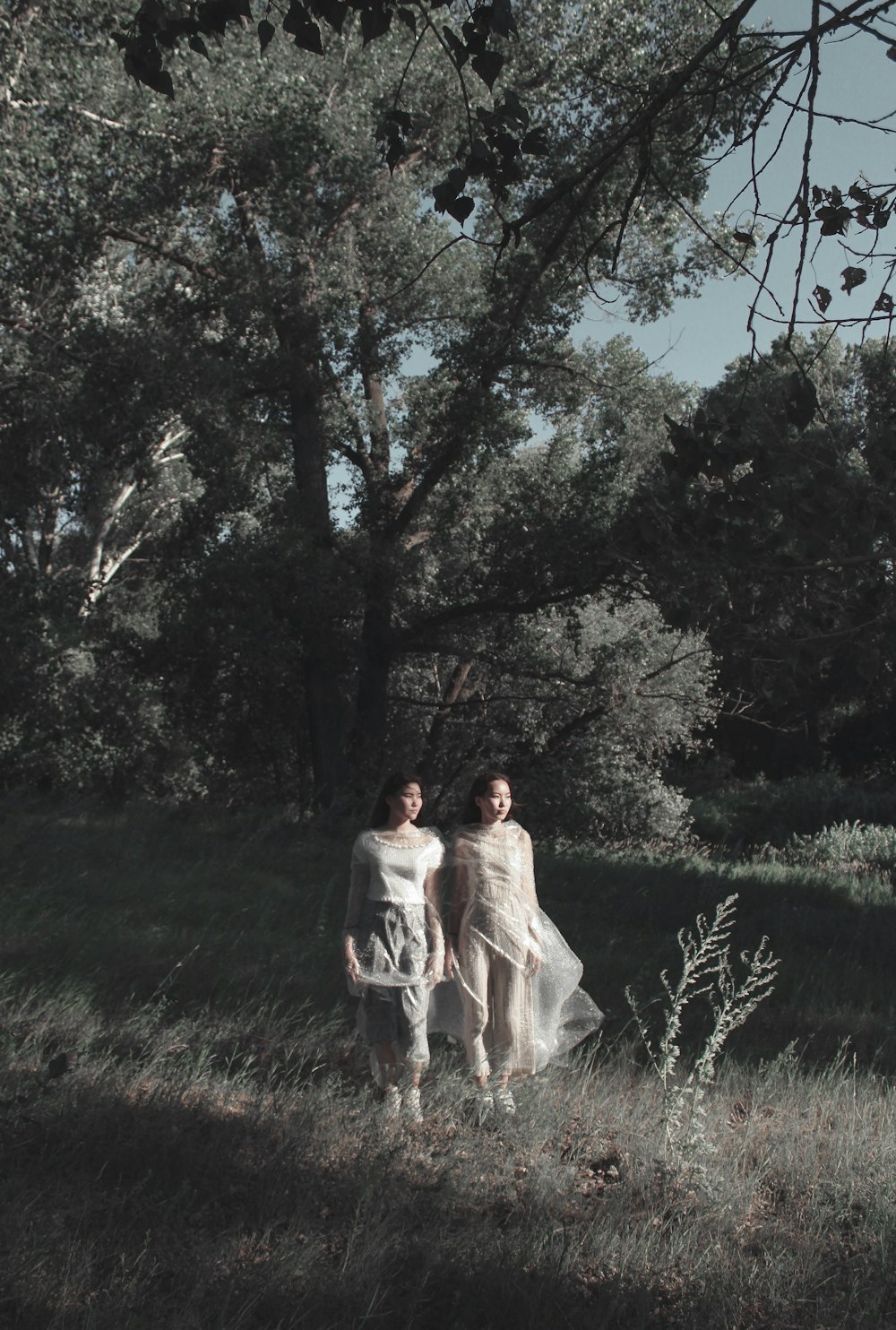 two women wearing white dress