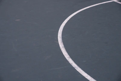 Close-up of high-quality sports flooring texture with clear markings for various sports.