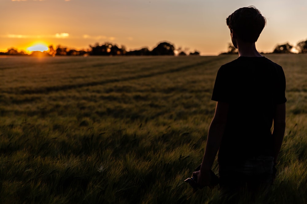 silhouette of person standing on green grass