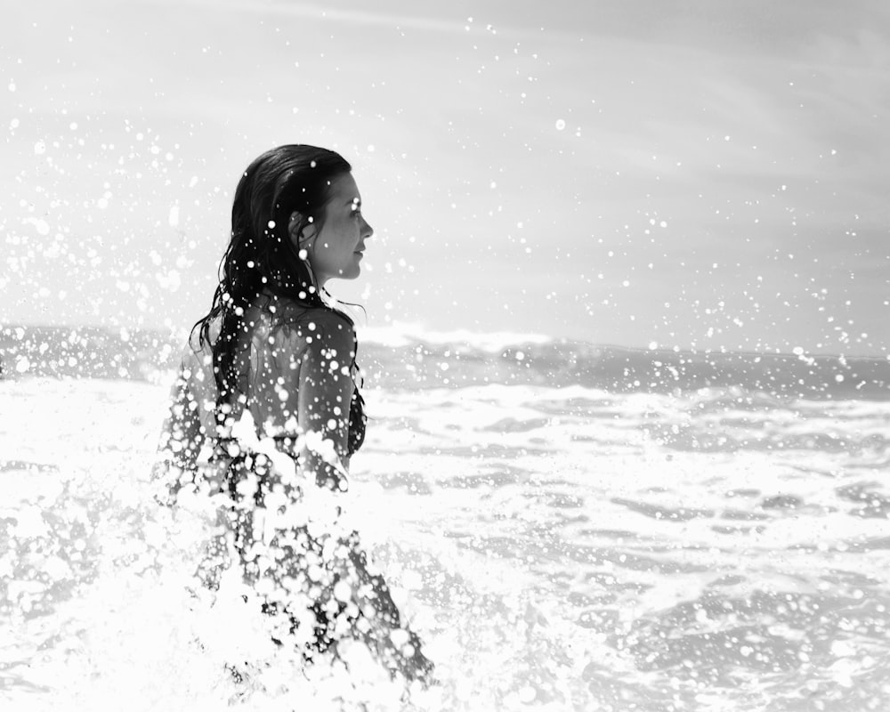 woman standing on body of water