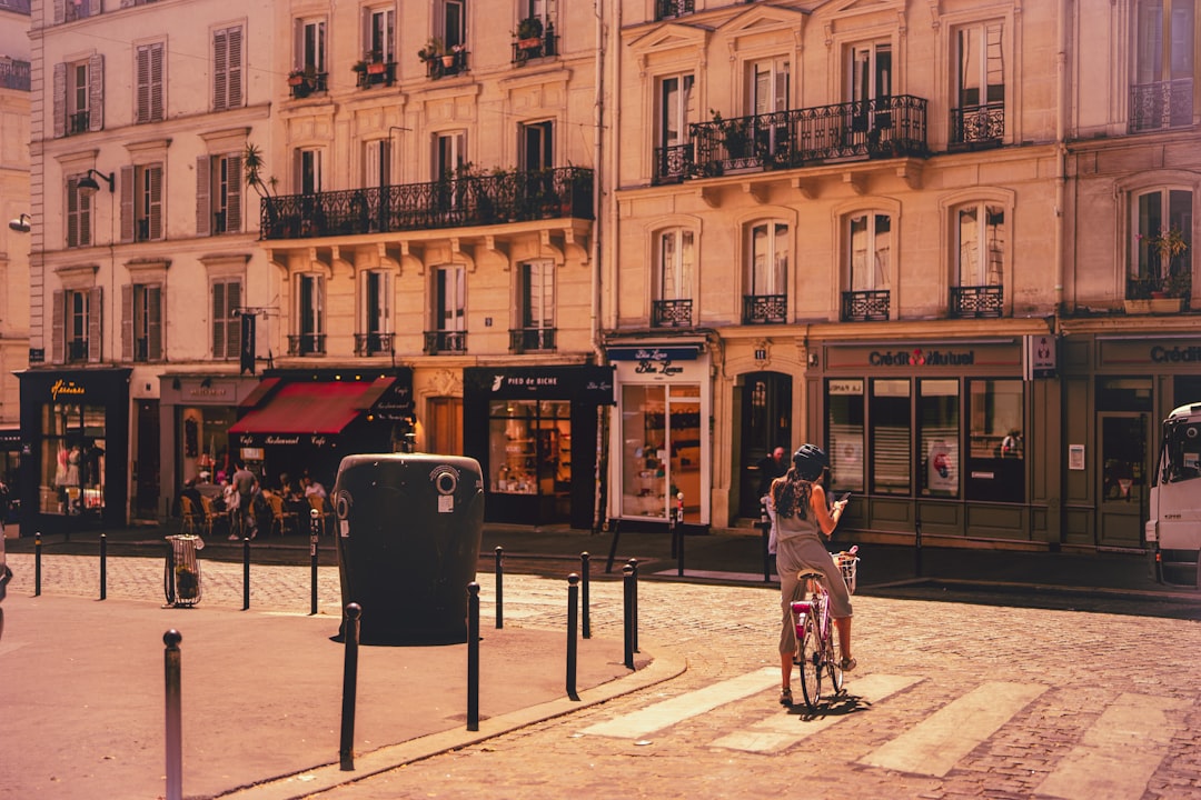 woman riding bicycle near building,
