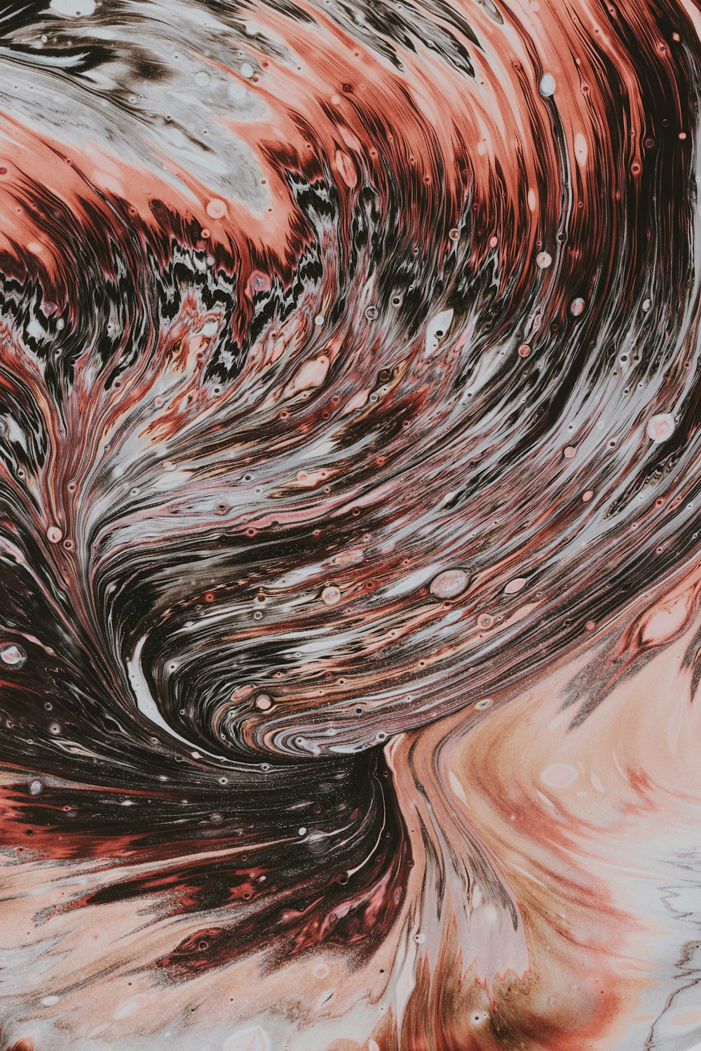 a close up of a red and black swirl